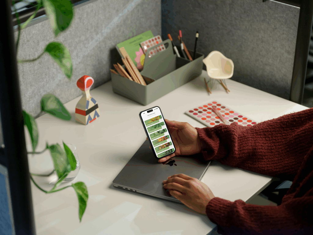 free mockup of woman holding iphone 14 pro (mockuuups studio)