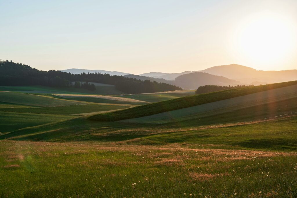 pexels photo 1205609 1205609 A breathtaking sunrise view of the rolling hills and fields in Oberösterreich, Austria.